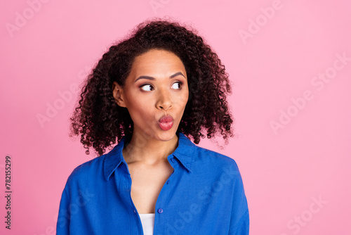 Photo of astonished impressed woman wear blue stylish clothes look empty space banner isolated on pink color background