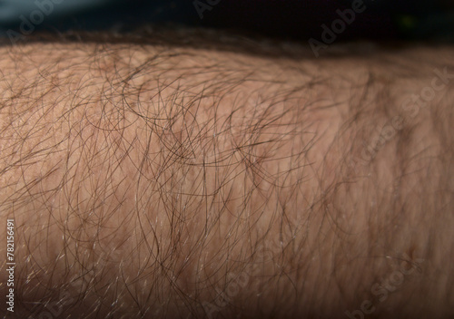 Hairy hand, arm in sun light, body hair close up in sun light in detail