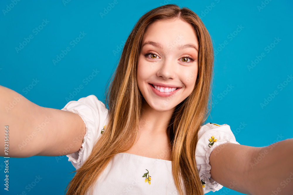 Photo of happy girl smiling make selfie isolated blue color background Photo of happy girl smiling make selfie isolated blue color background