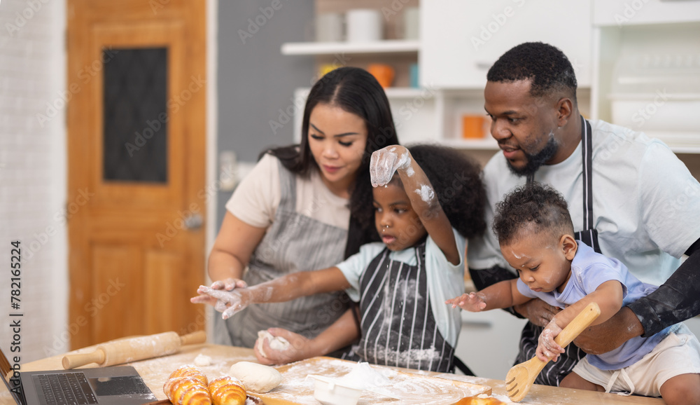 Obraz premium Family Bonding Over Baking Bread Using Online Recipe in Cozy Home Kitchen