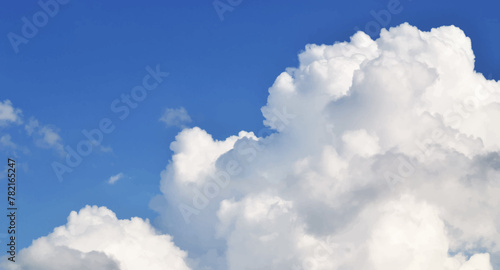 Large white cumulus cloud in a blue sky. Vector illustration, background. Horizontal frame.
