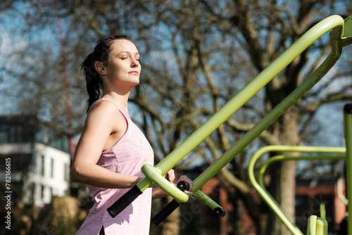 Caucasian fitness woman doing exercise in a gym outdoors.