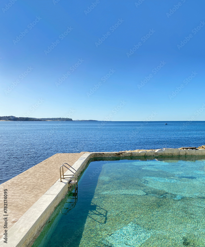 Public swimming pool near the ocean. Tidal pool. Rock Pool. Landscape, shore and view of the coast.