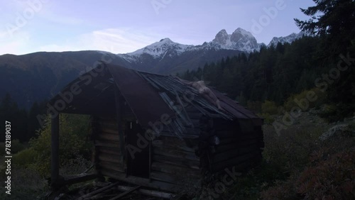 A serene video showcasing a person opening a window to reveal a breathtaking mountain range with trees in the foreground, perfect for nature lovers and travel enthusiasts photo