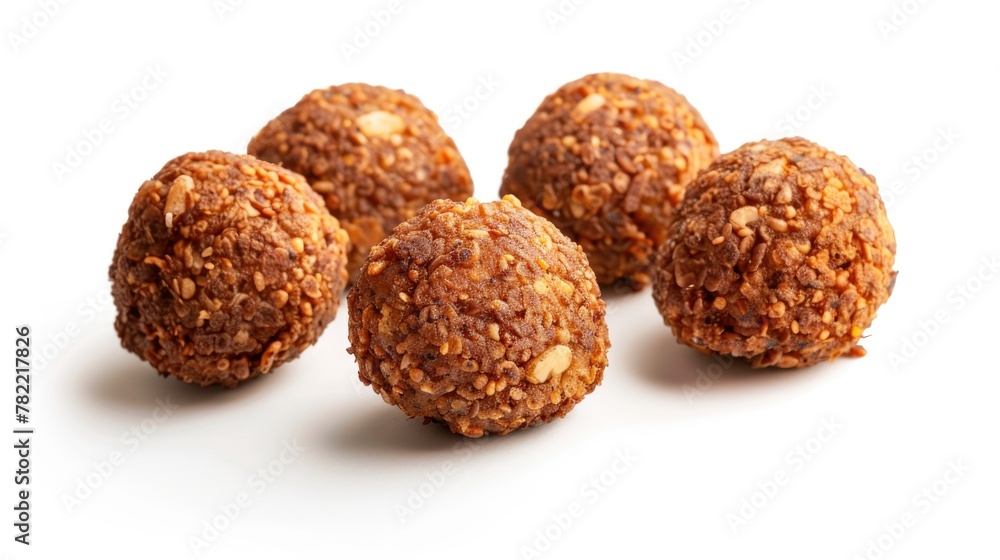 Close up of four balls of food on a white surface, suitable for food and nutrition concepts Close up of four balls of food on a white surface, suitable for food and nutrition concepts