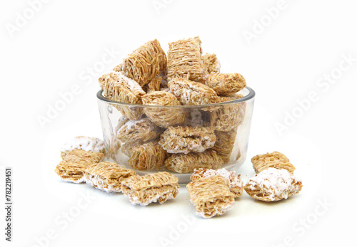 Breakfast setting with frosted wheat cereal on white background