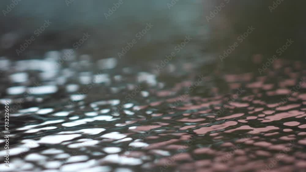 Texture of water flow on asphalt with light reflection. Close-up video of a flooded city street. Texture of water flow on asphalt with light reflection. Close-up video of a flooded city street.
