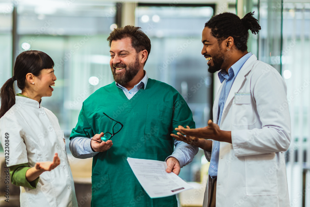 Fototapeta premium Group of multiracial doctors standing and discussing about results.