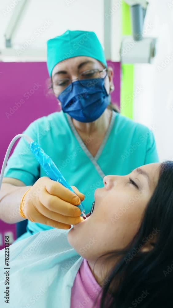 Latina Patient Receiving Ultrasound Dental Cleaning Latina Patient Receiving Ultrasound Dental Cleaning