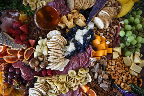 Closeup of a Charcuterie Board with a mixture of fruits, vegetables, meats and cheeses.