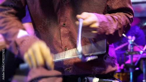 close-up of man playing triangle instrument at a music festival