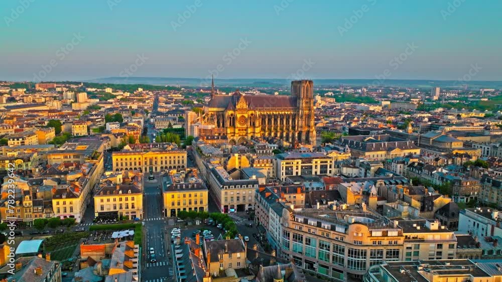 Gothic cathedral with twin towers at golden sunset in France. Reims city situated in a vine-growing country in which champagne wine is produced. Aerial view Cathedral of Notre-Dame of Reims, France. Gothic cathedral with twin towers at golden sunset in France. Reims city situated in a vine-growing country in which champagne wine is produced. Aerial view Cathedral of Notre-Dame of Reims, France.