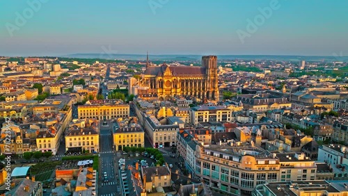 Gothic cathedral with twin towers at golden sunset in France. Reims city situated in a vine-growing country in which champagne wine is produced. Aerial view Cathedral of Notre-Dame of Reims, France.