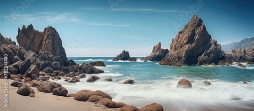 Rocky shore with crashing waves and blue sky
