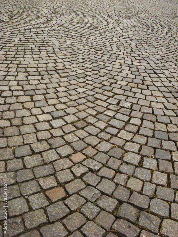 Circular placement of small square tiles on the pavement - obrazy, fototapety, plakaty 