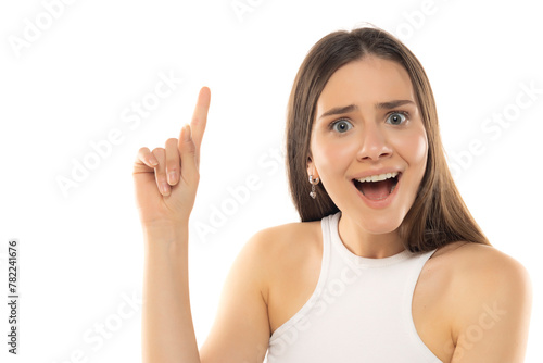 Portrait of young happy teenage girl with idea and finger up on white background