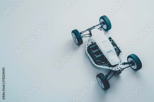 An electric toy car is displayed from above against a white backdrop.