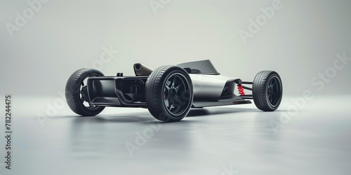 A silver electric race car sitting on a clean white surface, showcasing its sleek design and eco-friendly features.