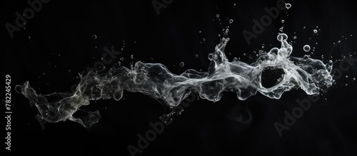 Smoke and water in motion on dark backdrop