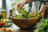 Woman mix fresh garden salad in wooden bowl
