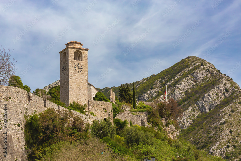 Old Bar (Stari Bar) fortress in Montenegro with a watchtower and lush greenery against a mountainous backdrop