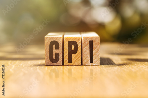 The text CPI, short for consumer price index on wooden cubes on the table, the concept of economic data.