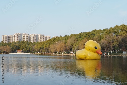 Giant inflatable yellow duck floating on the water in a lake park in Xiantao, China photo