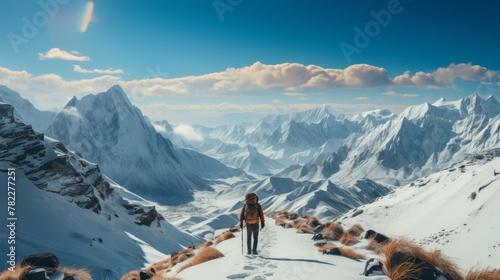 A lone hiker traverses a snowy mountain landscape