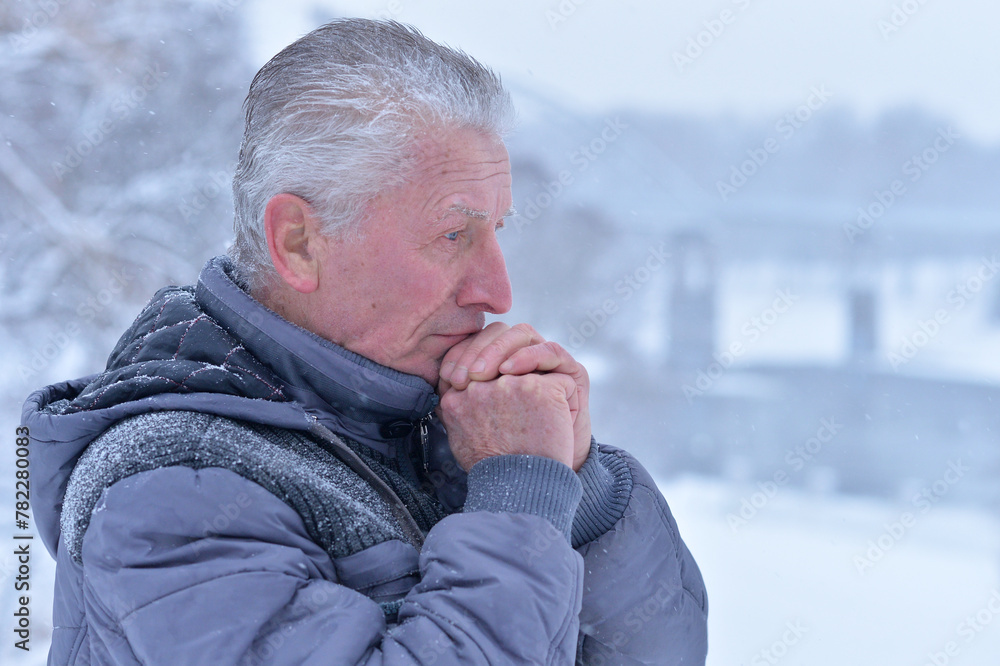 Portrait of thoughtful senior man at winter park Portrait of thoughtful senior man at winter park