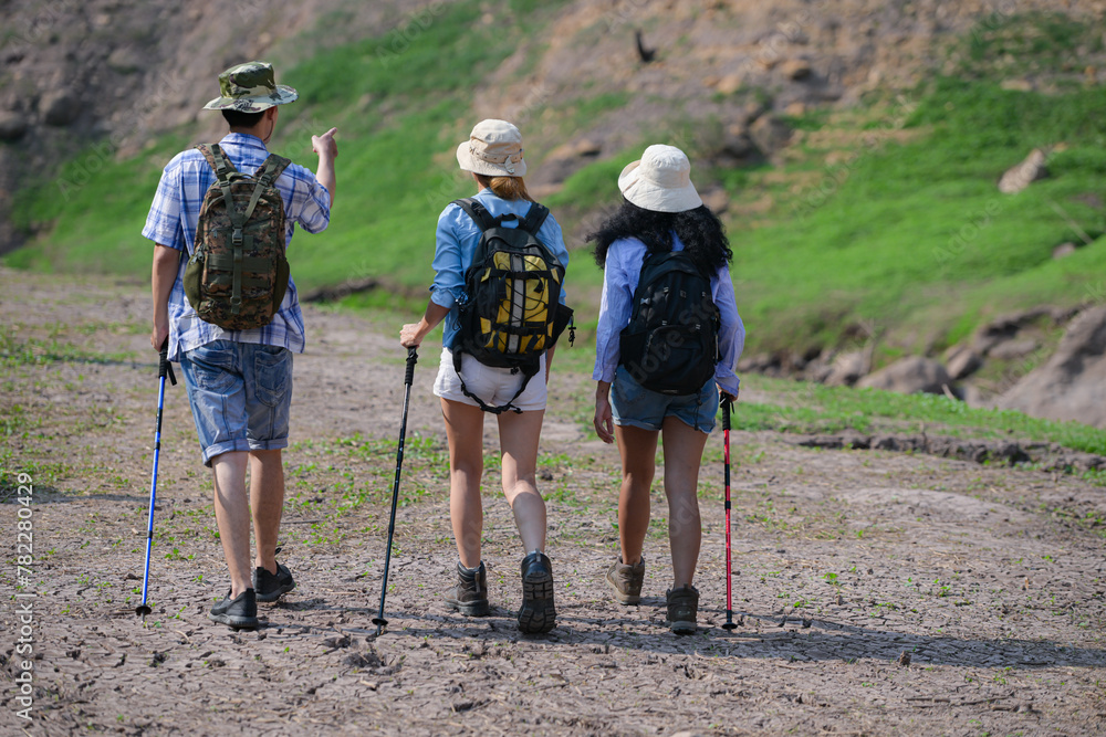 A group of friends going hiking in the streams of the tropical forest area.