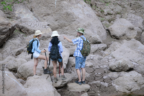A group of friends going hiking in the streams of the tropical forest area.