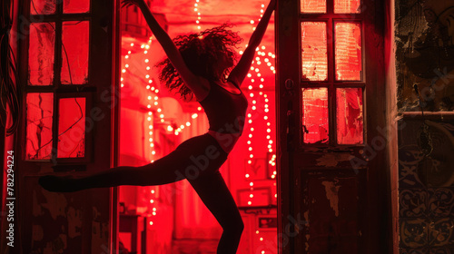 Woman silhouette dancing in the window - red light district concept