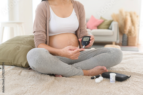Konstfotografi Pregnant woman checking blood sugar level by using Digital Glucose meter, health