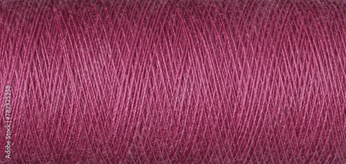 macro texture of a skein of red sewing thread