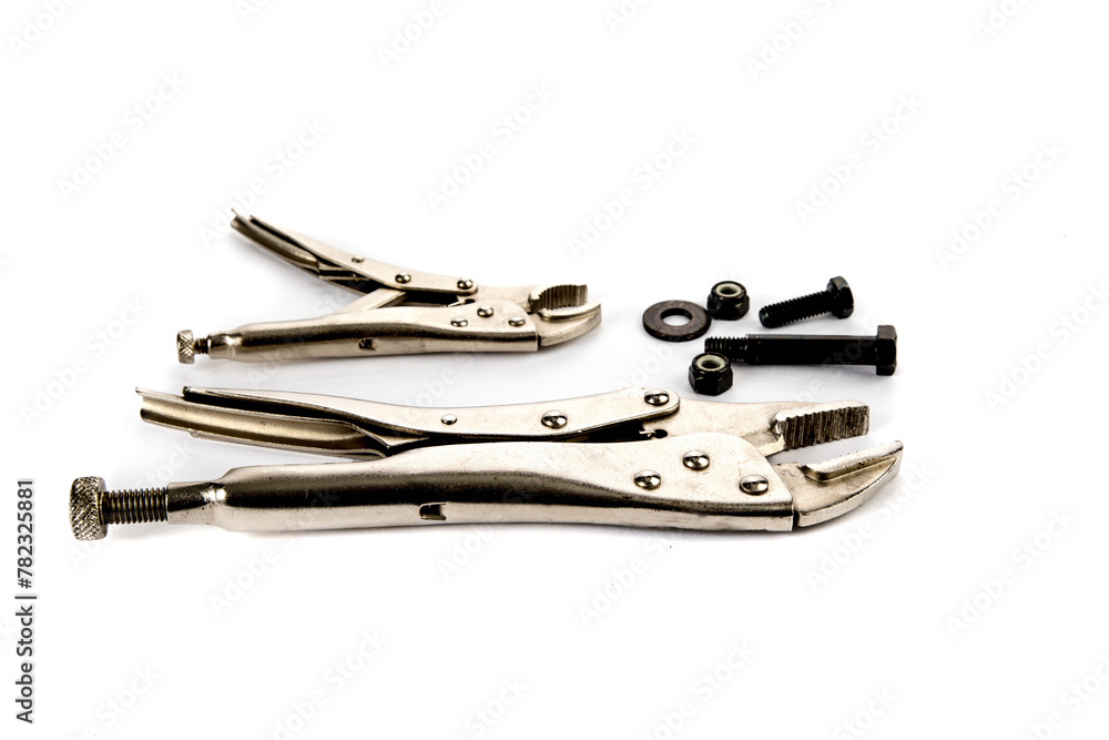 workshop handyman hand tools locking gripping pliers and nuts and bolts side view isolated on a white background workshop handyman hand tools locking gripping pliers and nuts and bolts side view isolated on a white background