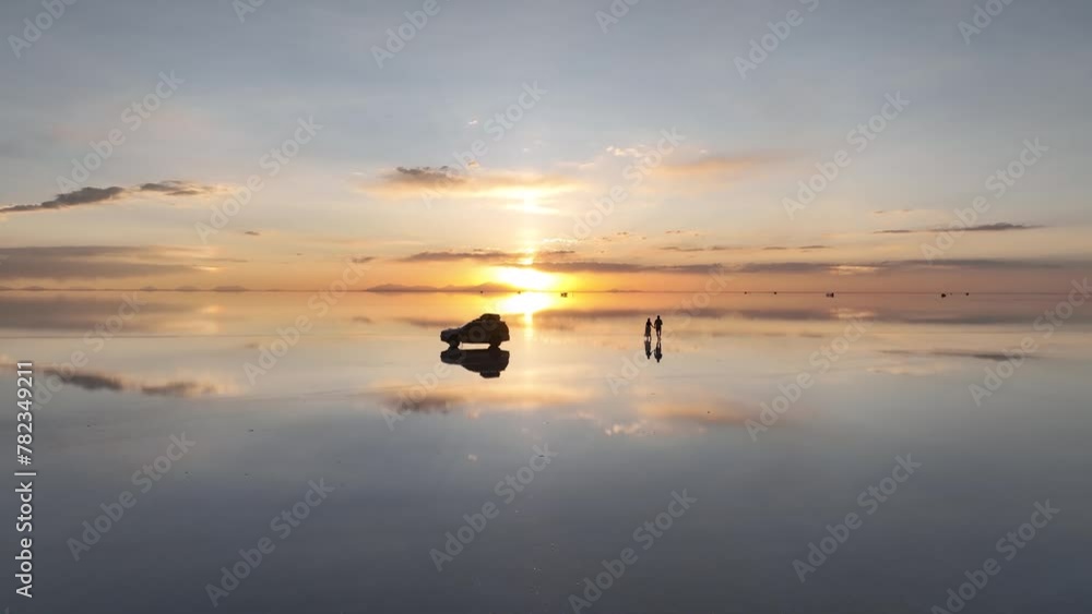 Salar de Uyuni in Bolivia during sunset. Aerial image taken with a drone. Uyuni Salt Flats. Altiplano, Bolivia. Rainy Season. Tunupa Volcano. Clouds Reflection on Water in Lake Surface Salar de Uyuni in Bolivia during sunset. Aerial image taken with a drone. Uyuni Salt Flats. Altiplano, Bolivia. Rainy Season. Tunupa Volcano. Clouds Reflection on Water in Lake Surface