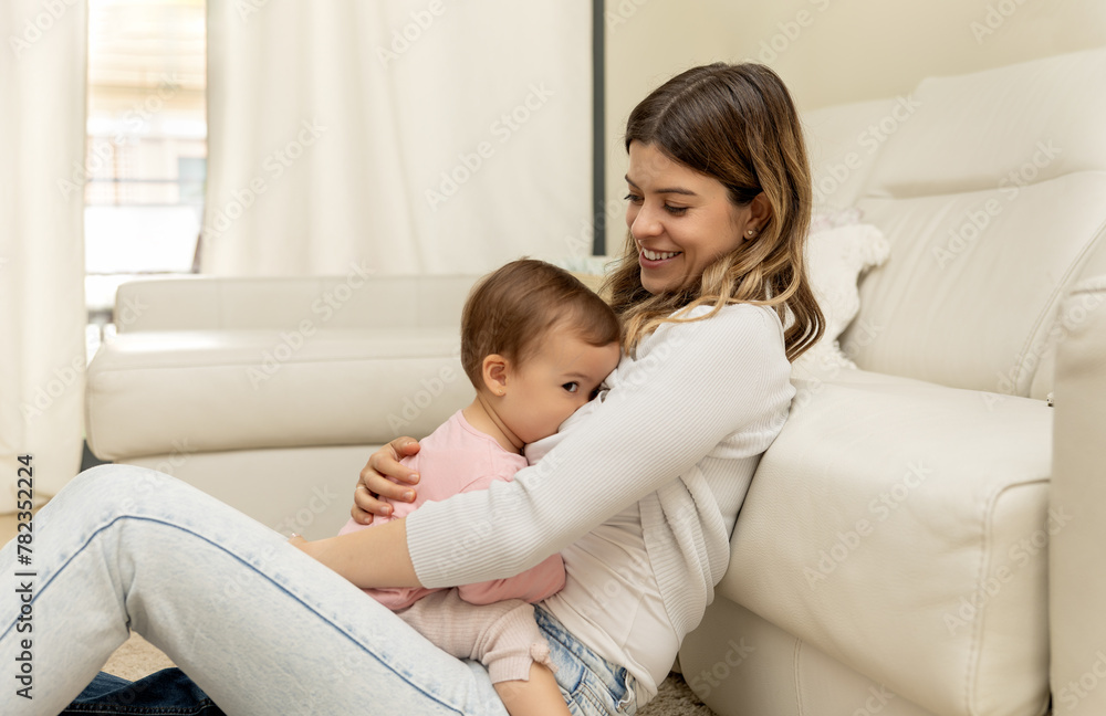 A young mother breastfeeding her daughter, establishing a unique emotional bond