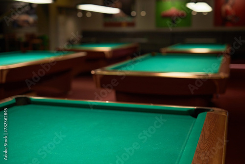 Detail background image of green billiard tables in gaming area at nightclub no people