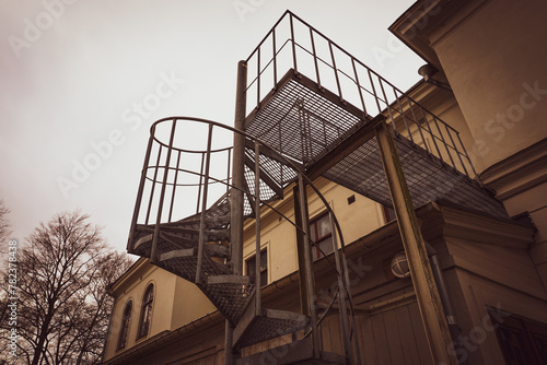 Low angle view of building with spiral staircase on the side