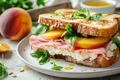 Ham peach and goat cheese sandwich on white plate