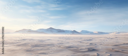 Snowy expanse with distant mountains