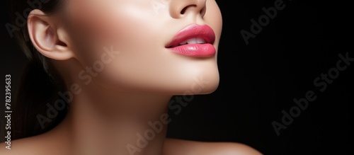 Woman s pink lipstick close-up on black background