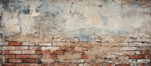 A worn brick wall with peeling red and white paint