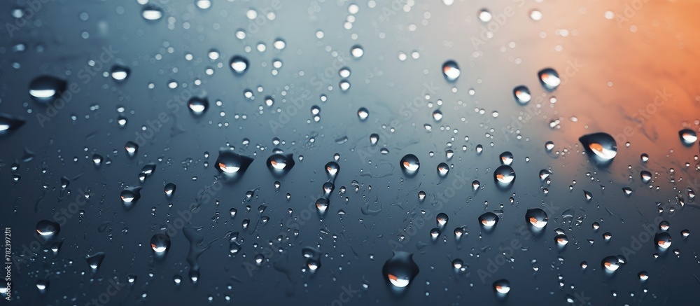 Water droplets on a glass window at sunset Water droplets on a glass window at sunset