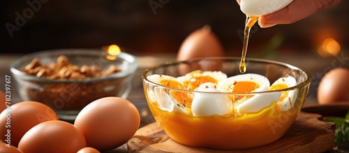 Person cracks eggs into bow...