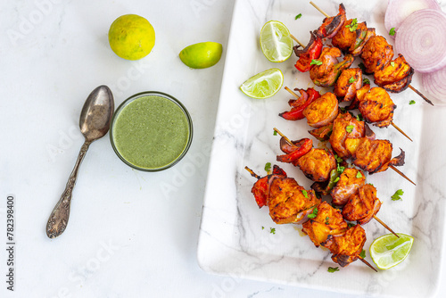 Indian Chicken Tikka Kebab with Green Chutney, Onion, and Cilantro Top Down Photo