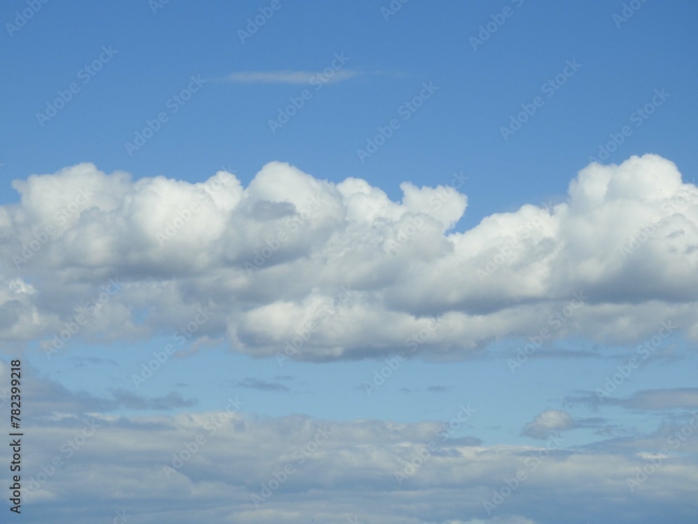 Cloudscape, puffy clouds in a blue sky over the Bombay Hook National Wildlife Refuge, Kent County, Delaware. Cloudscape, puffy clouds in a blue sky over the Bombay Hook National Wildlife Refuge, Kent County, Delaware.