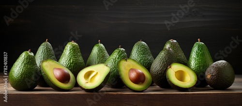 Group of ripe avocados on w...