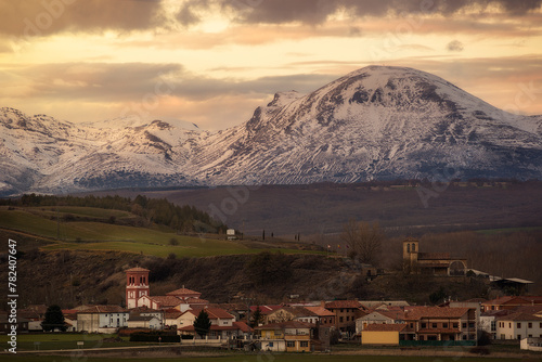 Sunset scene of Buenavista de Valdavia, a typical Castilian town in the province of Palencia. In the background the Peña Redonda and other mountains of the Palentina Mountain covered in snow photo
