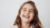 Studio photo of a cheerful girl laughing at the camera on white background